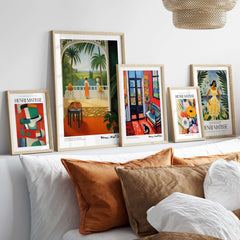 Matisse Art Prints - Woman on Balcony Sea View Poster displayed on a stylish wall above a cozy sofa with decorative pillows.