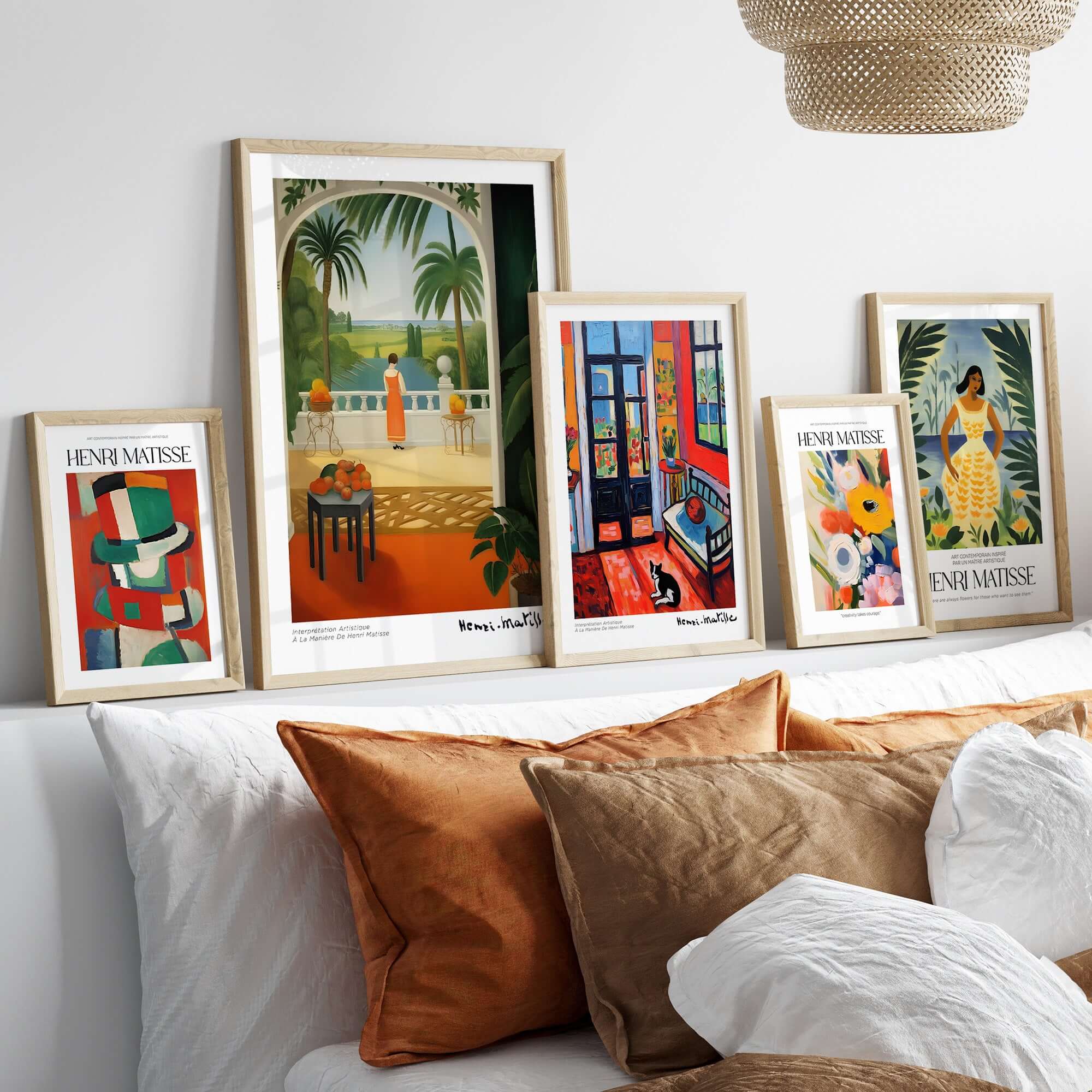Matisse Art Prints - Woman on Balcony Sea View Poster displayed on a stylish wall above a cozy sofa with decorative pillows.
