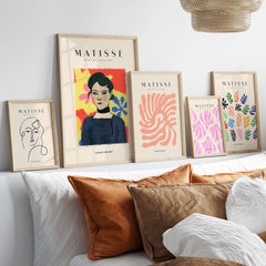 Matisse Art Prints - Woman Portrait Abstract Floral Poster displayed in a stylish living room setting with vibrant colors.