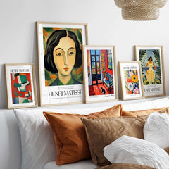 Matisse Art Prints - Woman Portrait Wall Art displayed on a shelf with various framed artworks in modern decor.