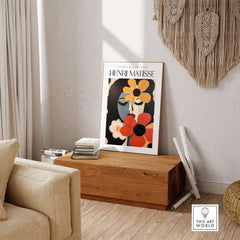 Matisse Art Prints -  Woman with Flowers Abstract Art Print displayed in a cozy living room with wooden furniture.