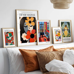 Matisse Art Prints - Woman with Flowers Abstract Art Print displayed among other Matisse artworks on a stylish home decor shelf.