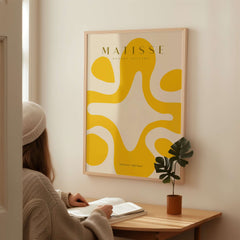 Matisse Art Prints -   Yellow Abstract Fluid Shape Poster displayed in modern interior, highlighting vibrant yellow shapes.