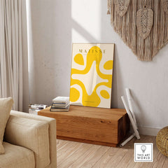 Matisse Art Prints -   Yellow Abstract Fluid Shape Poster displayed in a stylish living room setting.