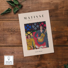 Matisse Art Prints - Two Women Guitar Interior Scene Poster displayed on a wooden table, featuring two women and a guitar.
