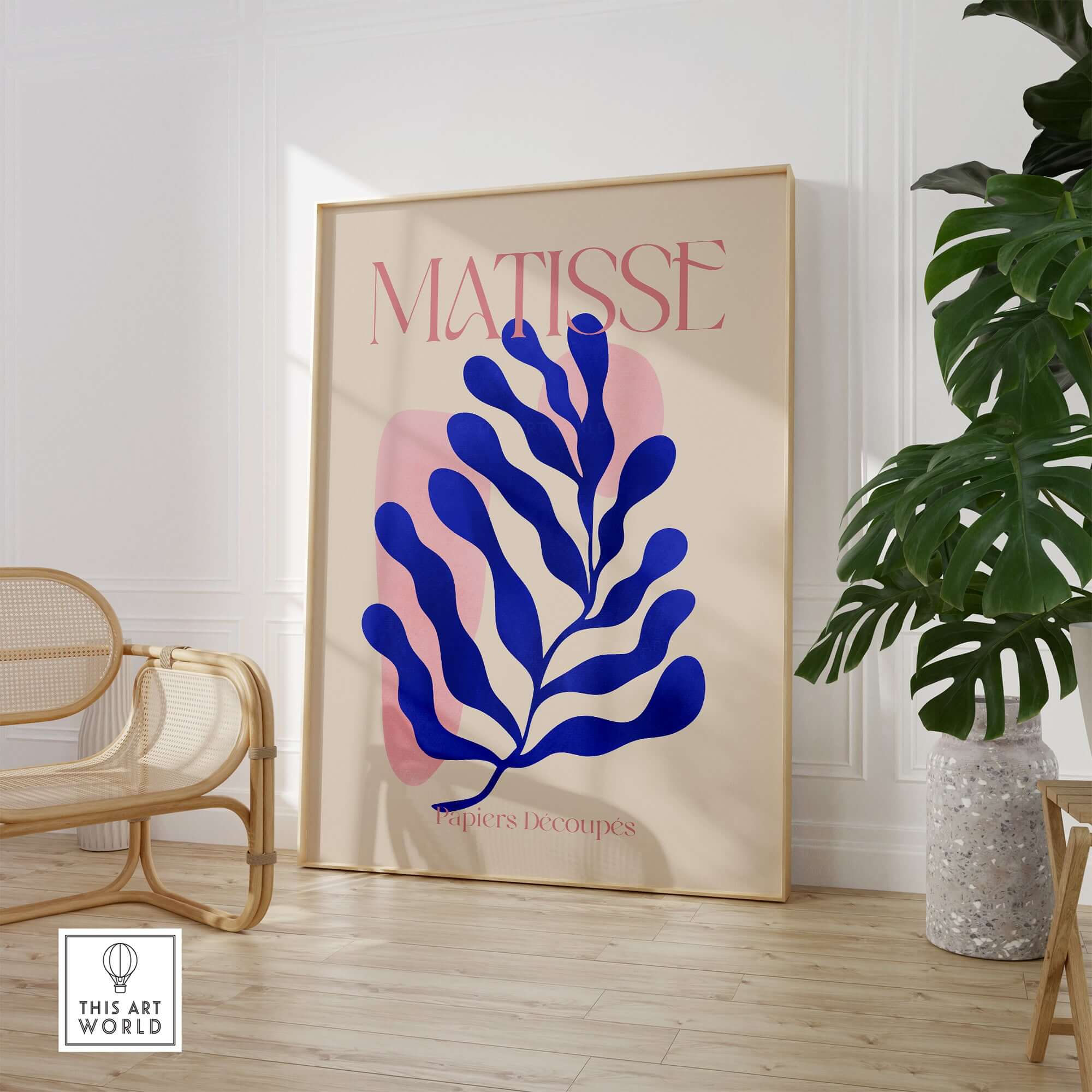 Matisse Blue Leaf Abstract Papiers Découpés Wall Art Print displayed in a modern room with plants and stylish furniture.