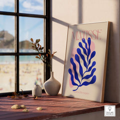Matisse Blue Leaf Abstract Papiers Découpés Wall Art Print displayed on wooden ledge near a window