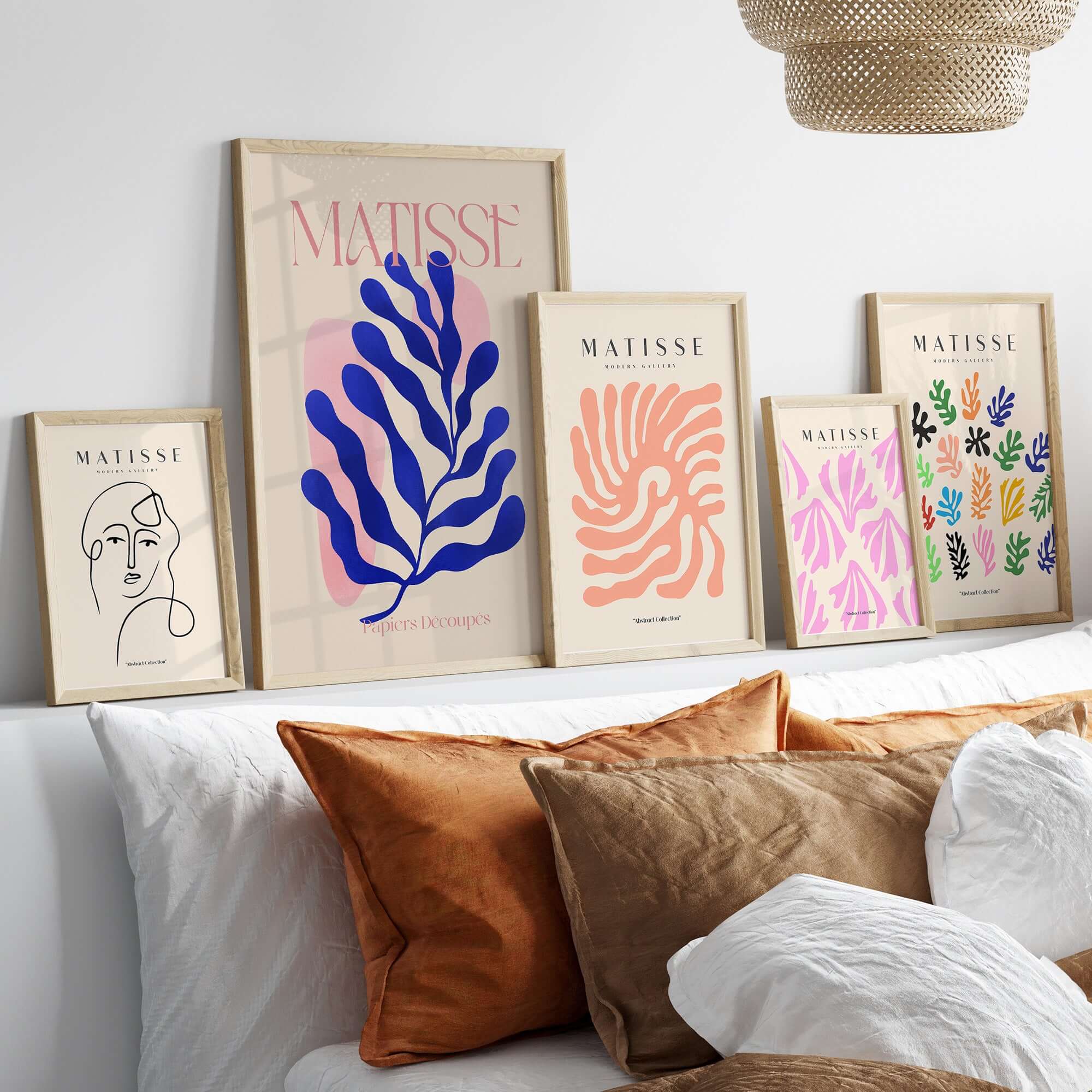 Matisse Blue Leaf Abstract Papiers Découpés Wall Art Print displayed on a wall with framed art featuring organic shapes.