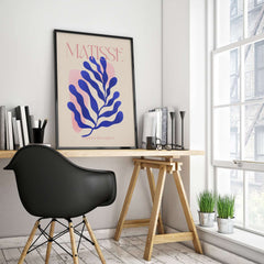 Matisse Blue Leaf Abstract Papiers Découpés Wall Art Print displayed in a modern workspace with a black chair.