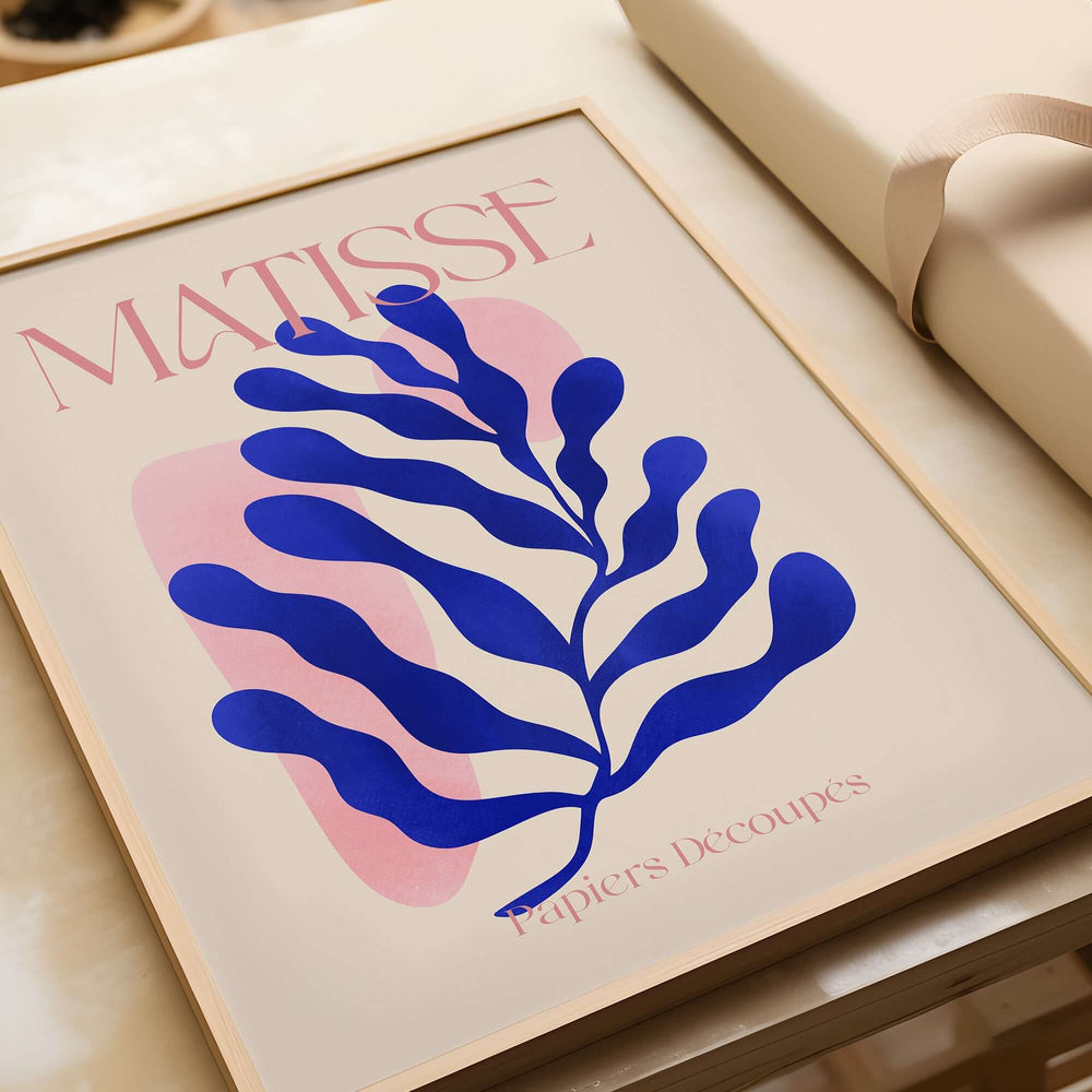 Matisse Blue Leaf Abstract Papiers Découpés Wall Art Print showcasing a blue leaf design on a soft beige background.