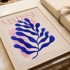 Matisse Blue Leaf Abstract Papiers Découpés Wall Art Print showcasing a blue leaf design on a soft beige background.