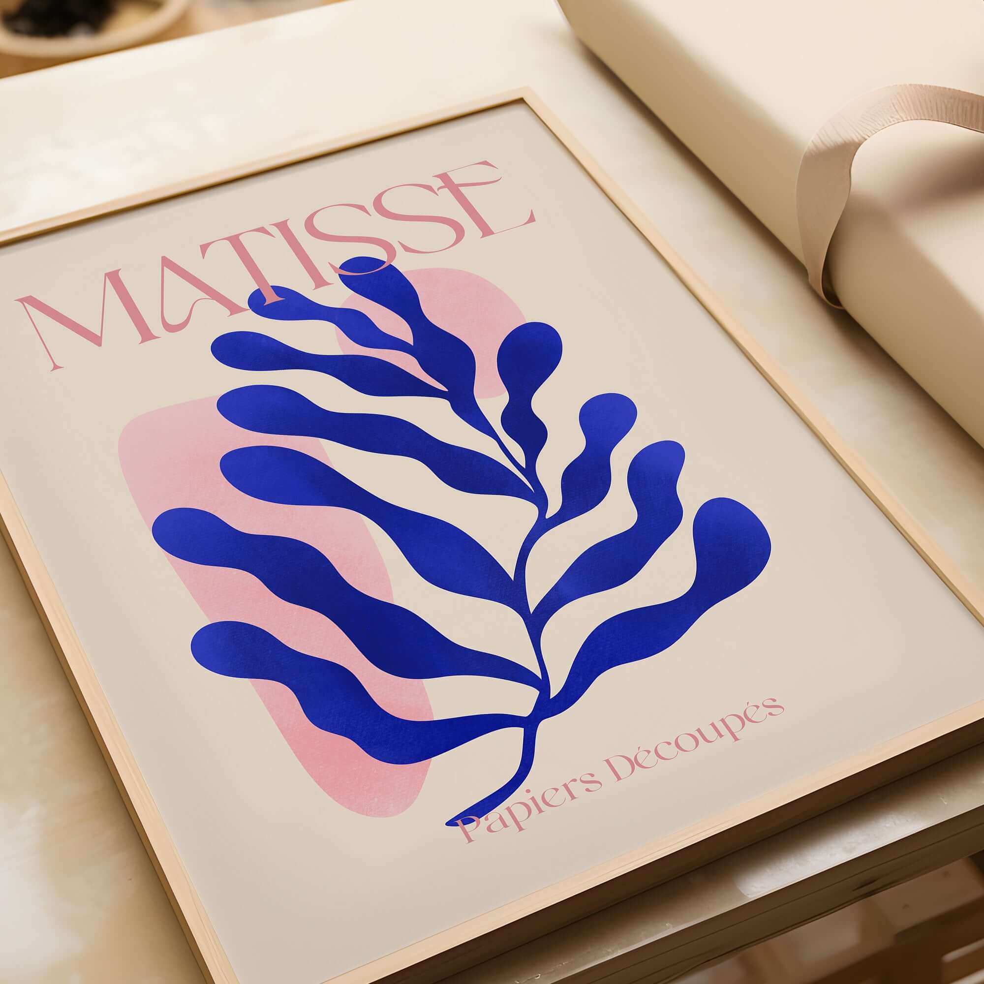 Matisse Blue Leaf Abstract Papiers Découpés Wall Art Print showcasing a blue leaf design on a soft beige background.