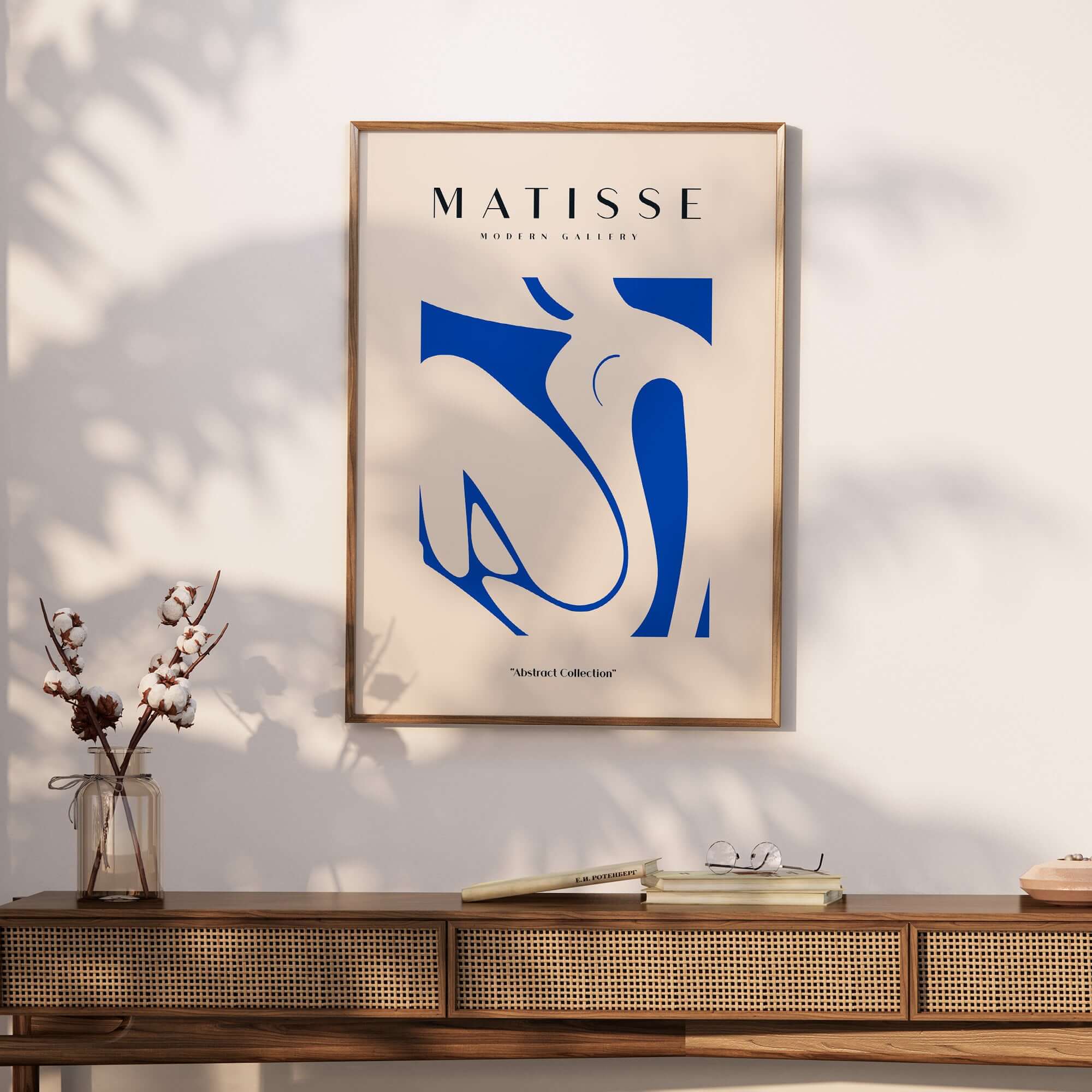 Matisse Art Prints - Blue Nude Abstract Cut Out Wall Art displayed in a modern interior setting with a wooden console.