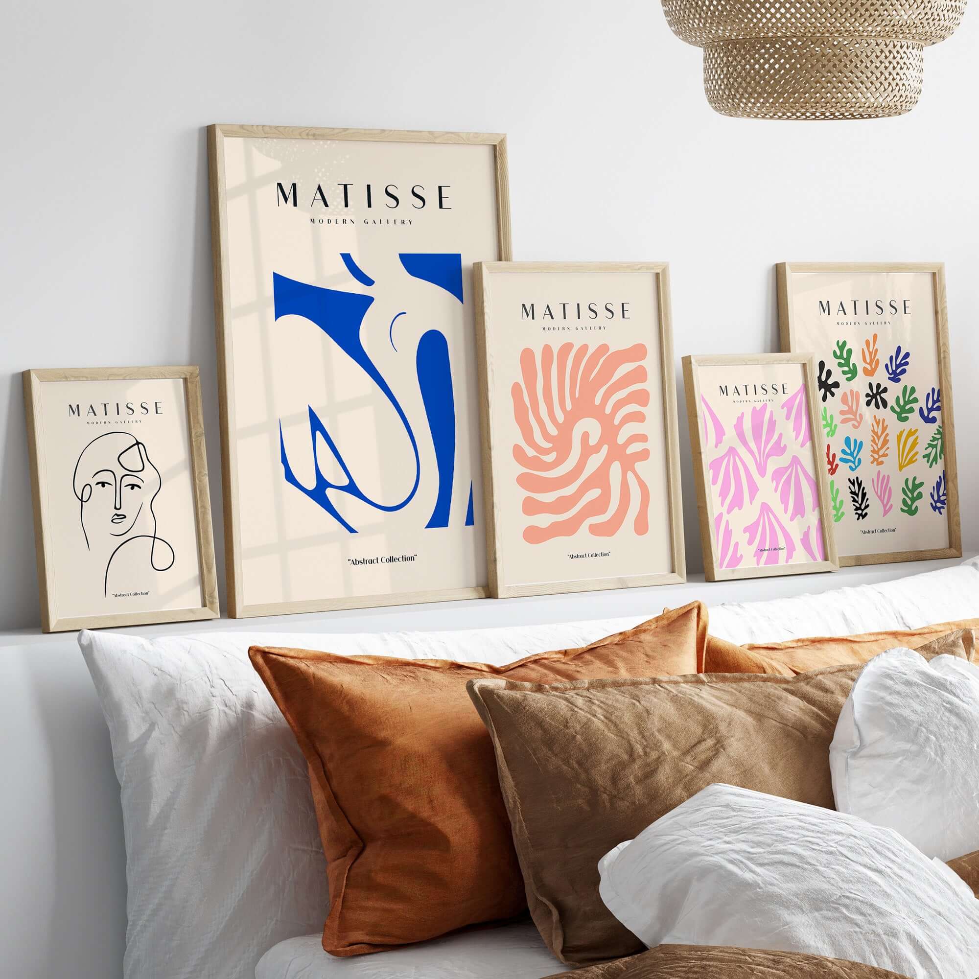 Matisse Art Prints - Blue Nude Abstract Cut Out Wall Art displayed on a shelf with decorative pillows.