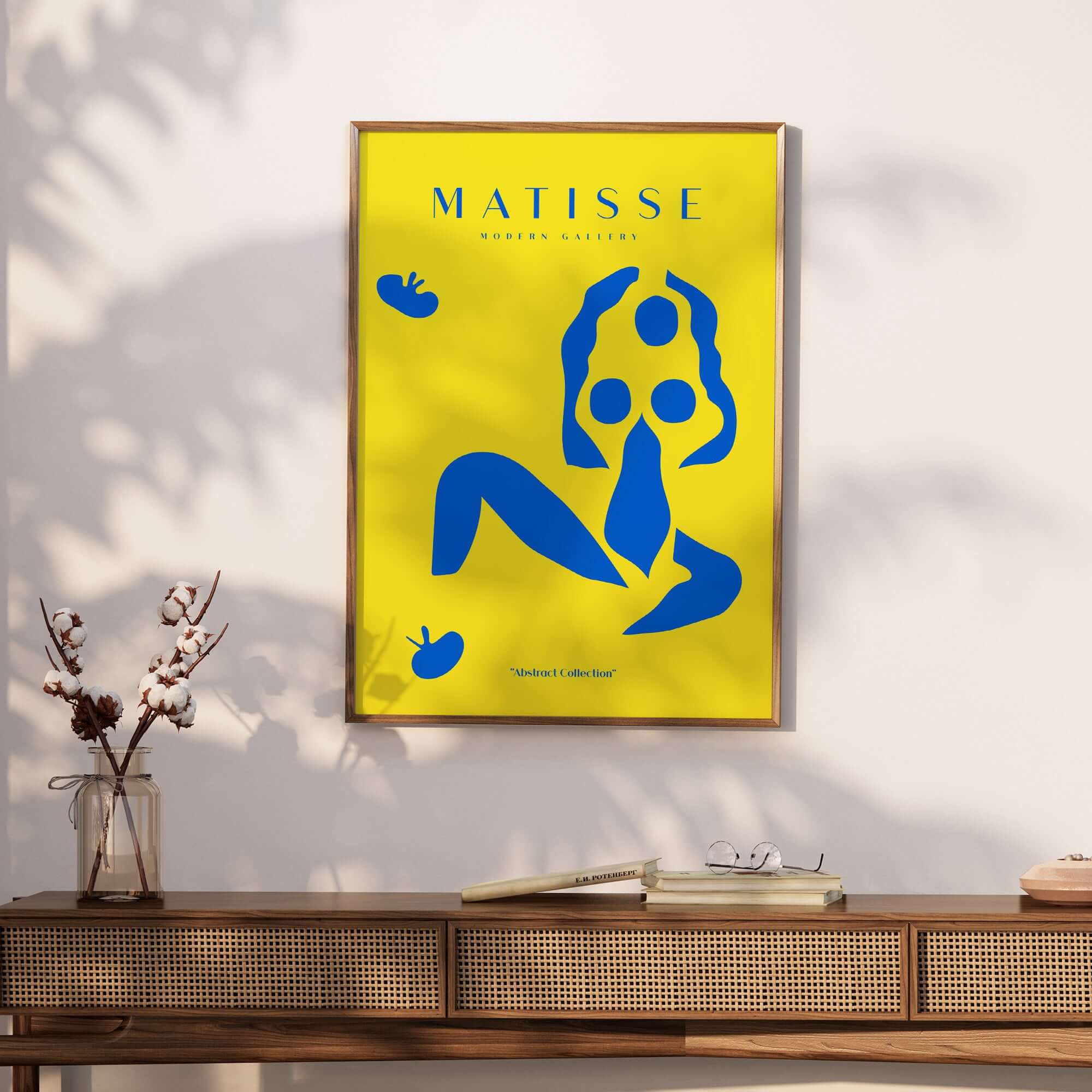 Matisse Art Prints - Blue Nude Abstract Figure Yellow Poster displayed on wall above wooden table with flower vase.