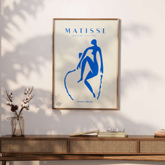 Matisse Art Prints -  Blue Nude Seated Figure Poster displayed on a wall above a modern wooden console.