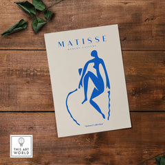 Matisse Art Prints -  Blue Nude Seated Figure Poster showcasing a blue silhouette on a beige background.