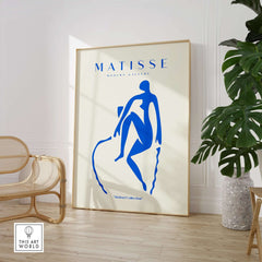 Matisse Art Prints -  Blue Nude Seated Figure Poster displayed in a stylish interior with a chair and plant.