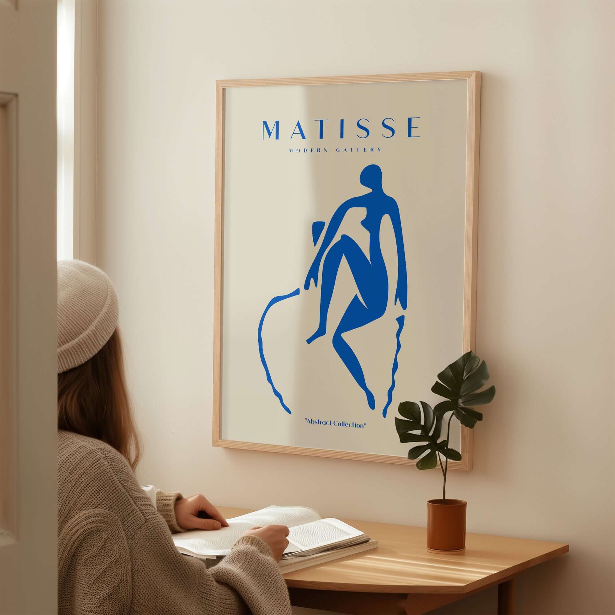 Matisse Art Prints -  Blue Nude Seated Figure Poster displayed on a wall, featuring a blue silhouette on beige background.