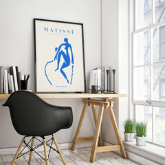 Matisse Art Prints -  Blue Nude Seated Figure Poster displayed in a modern workspace with minimalist decor.