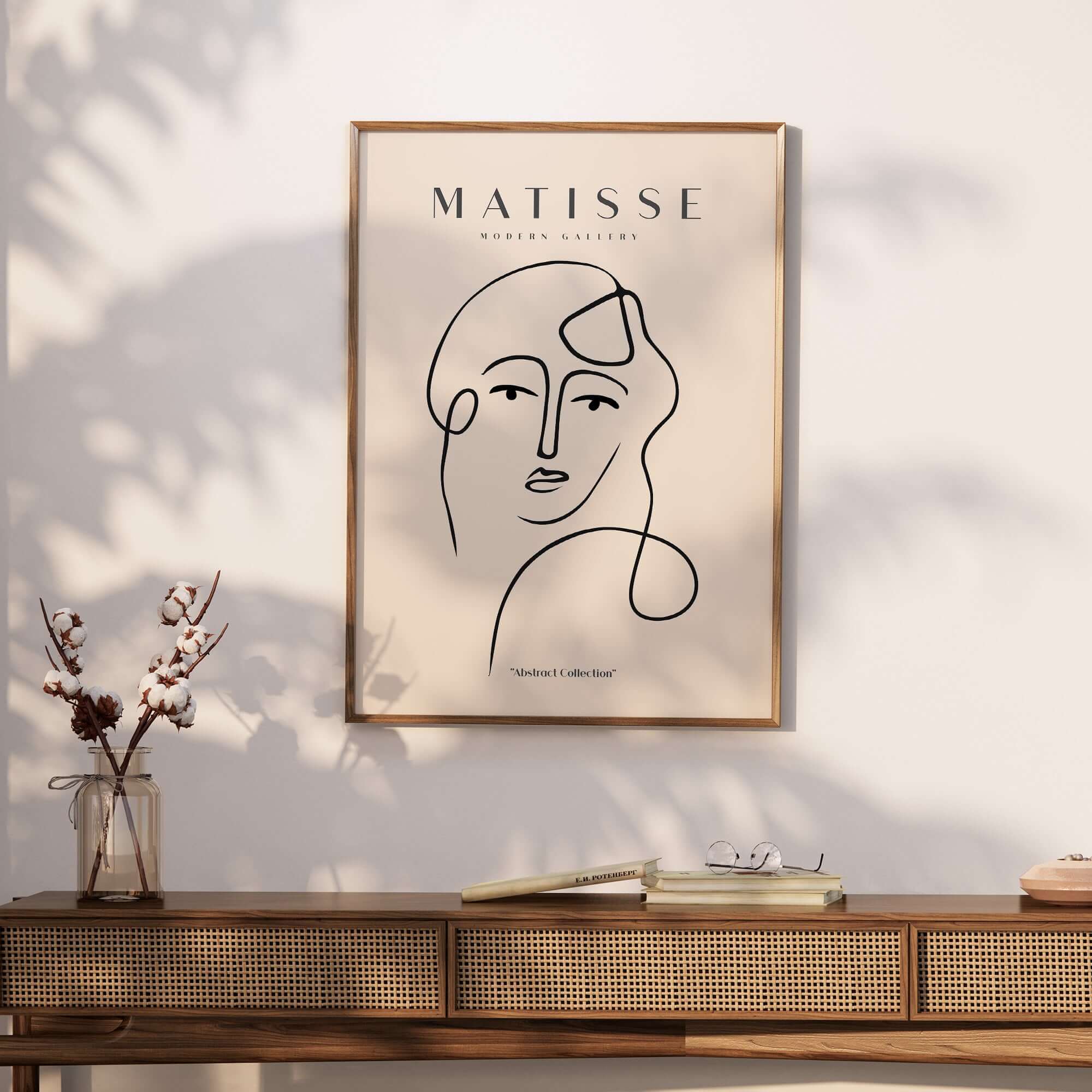 Matisse Art Prints - Continuous Line Abstract Face Poster displayed on a wall above a wooden console table.