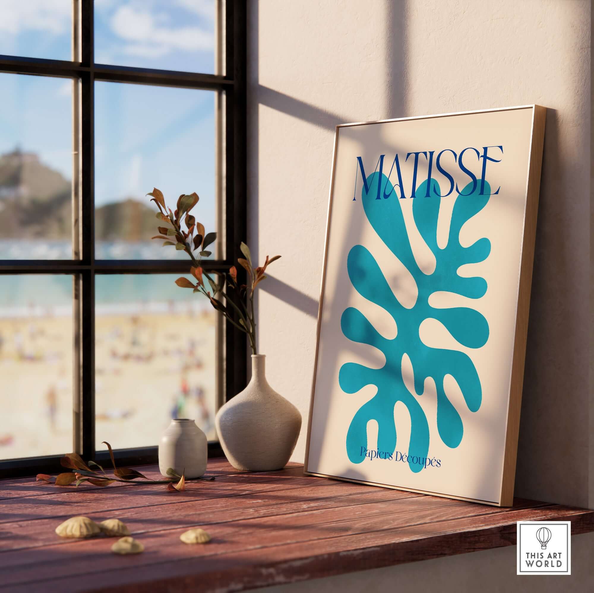 Matisse Cyan Blue Abstract Shape Papiers Découpés Poster displayed by a window, showcasing vibrant blue shapes.