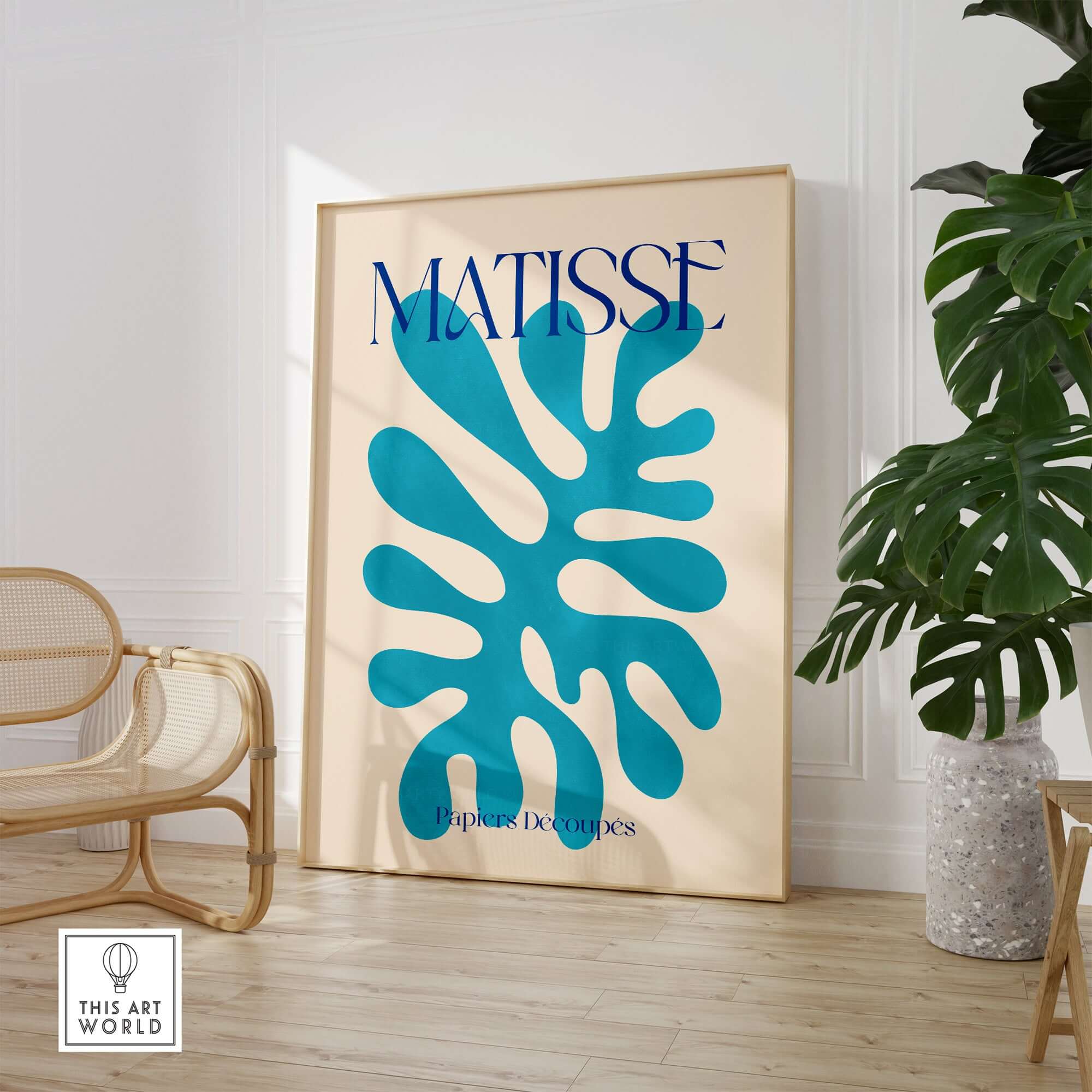 Matisse Cyan Blue Abstract Shape Papiers Découpés Poster displayed in a modern living space with potted plant.