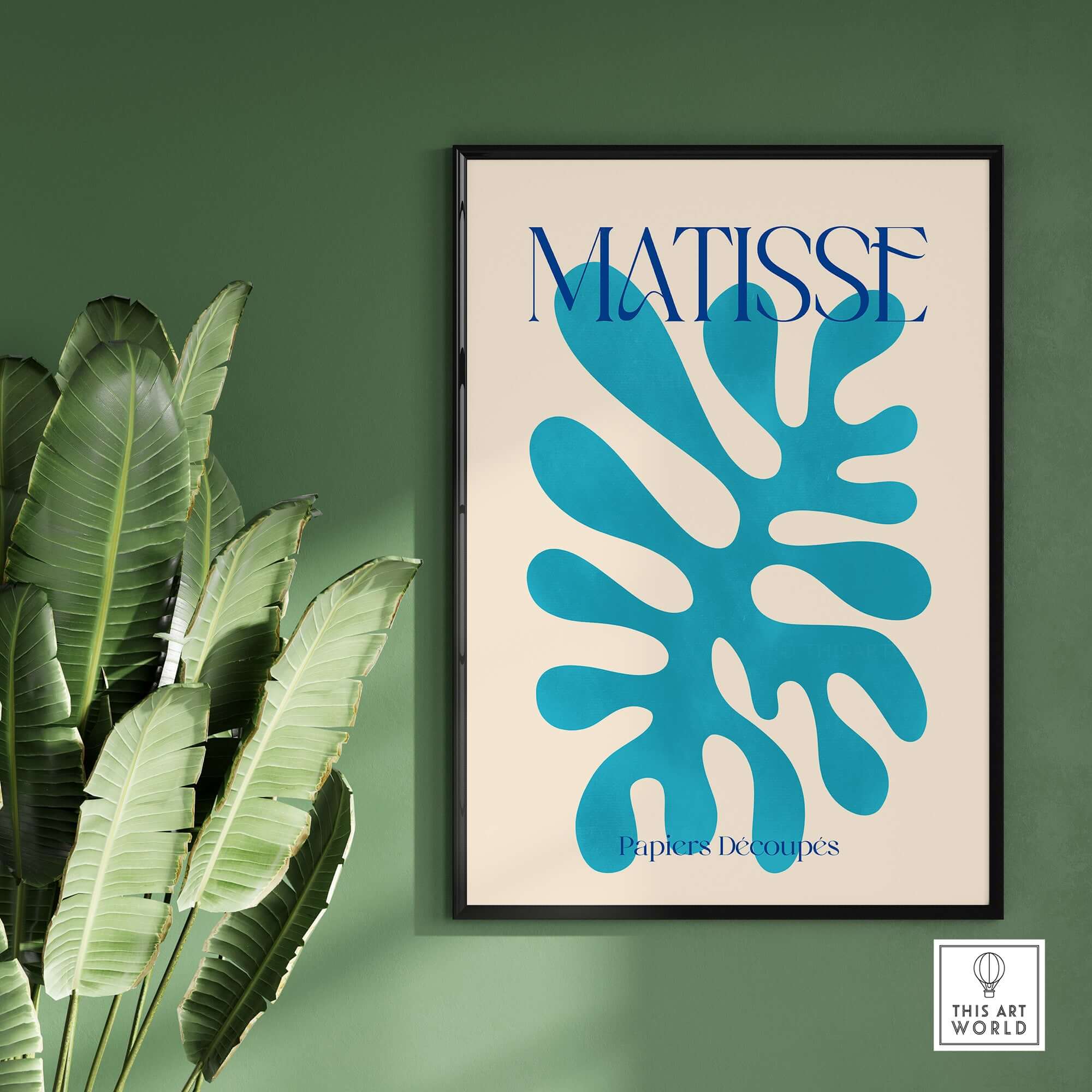 Matisse Cyan Blue Abstract Shape Papiers Découpés Poster displayed on a green wall with large leaves.