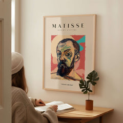 Matisse Art Prints - Expressive Self Portrait Poster framed on wall above a person studying at a table.