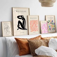 Matisse Art Prints - Figurative Lady Poster Art displayed on a wall with stylish accessories and pillows.