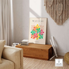 Matisse Art Prints - Interlocking Colorful Leaves Abstract Print displayed in a stylish living room setting on a wooden table.