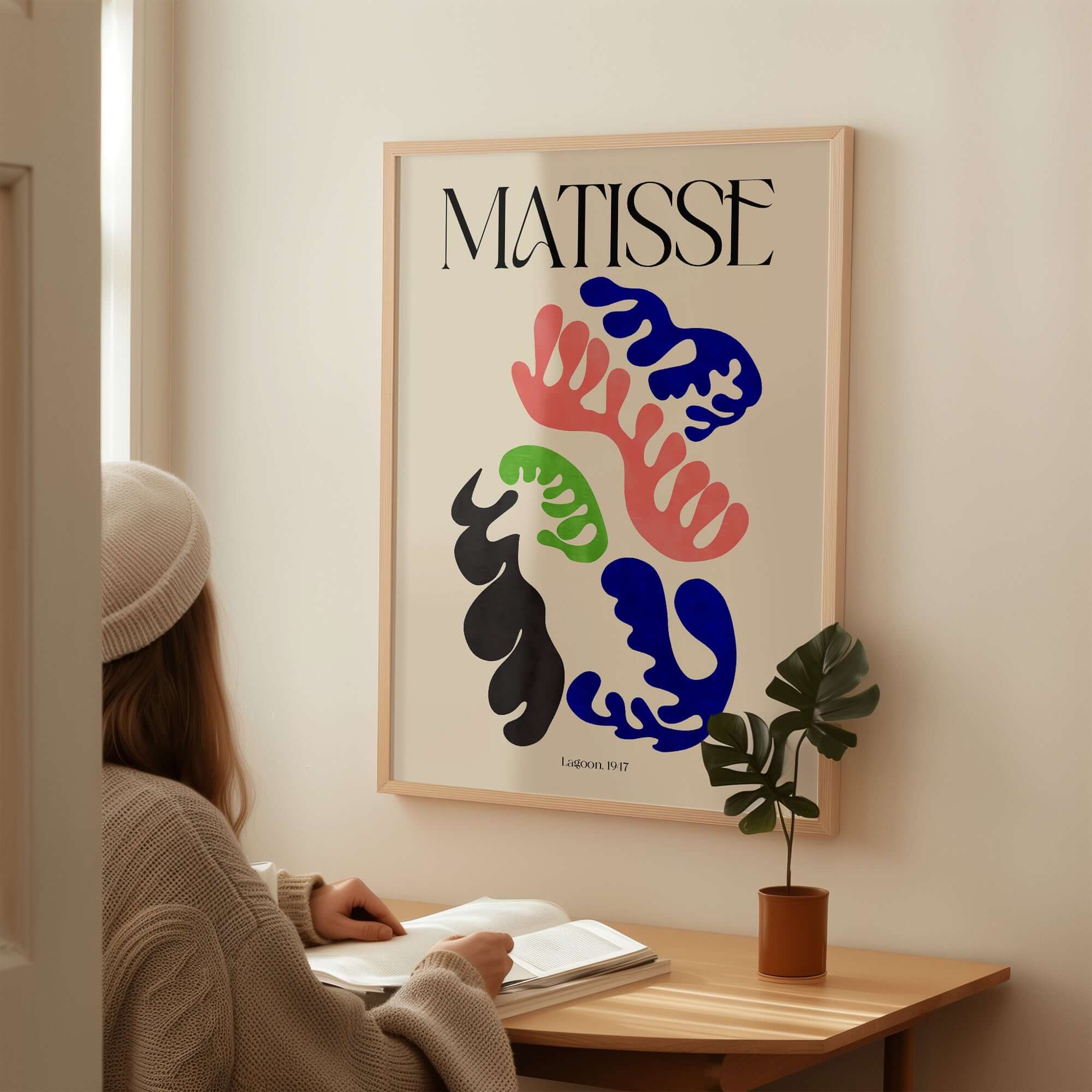 Matisse Art Print Lagoon 1947 Abstract Organic Shapes Wall Art Print showcased in a modern room with a person reading.