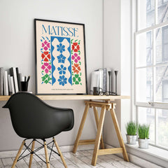Matisse Large Decoration with Masks Vertical Panel Art Print displayed in a modern workspace with black chair and plants.
