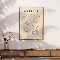 Matisse Art Prints -  Line Art Ladies Face with Wavy Hair Minimalist Poster displayed in a stylish interior setting.