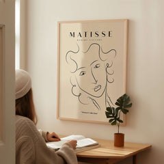 Matisse Art Prints -  Line Art Ladies Face with Wavy Hair Minimalist Poster in a cozy room setting.