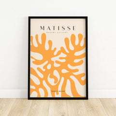 Matisse Art Prints - Orange Abstract Coral Pattern Poster displayed in a black frame on a wooden floor.