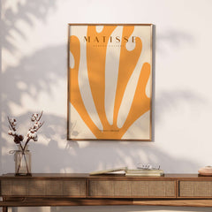 Matisse Art Prints -  Orange Fan Coral Abstract Shape Poster displayed on a wall with a wooden console beneath it.