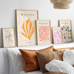 Matisse Art Prints - Orange Seaweed Abstract Art Print displayed on a wall above a sofa with decorative pillows.