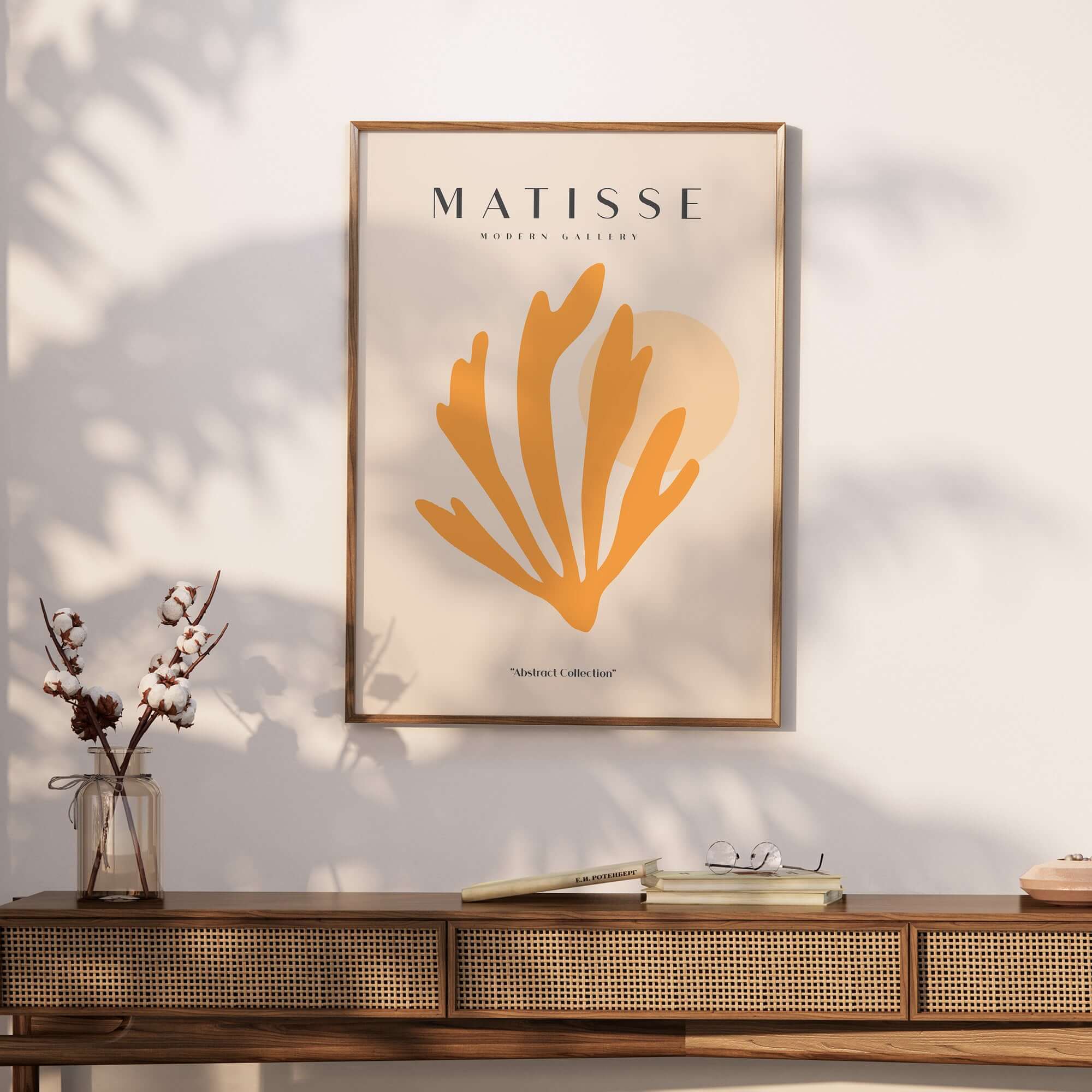 Matisse Art Prints - Orange Seaweed Abstract Art Print displayed on a wall above a wooden table with decorative flowers.