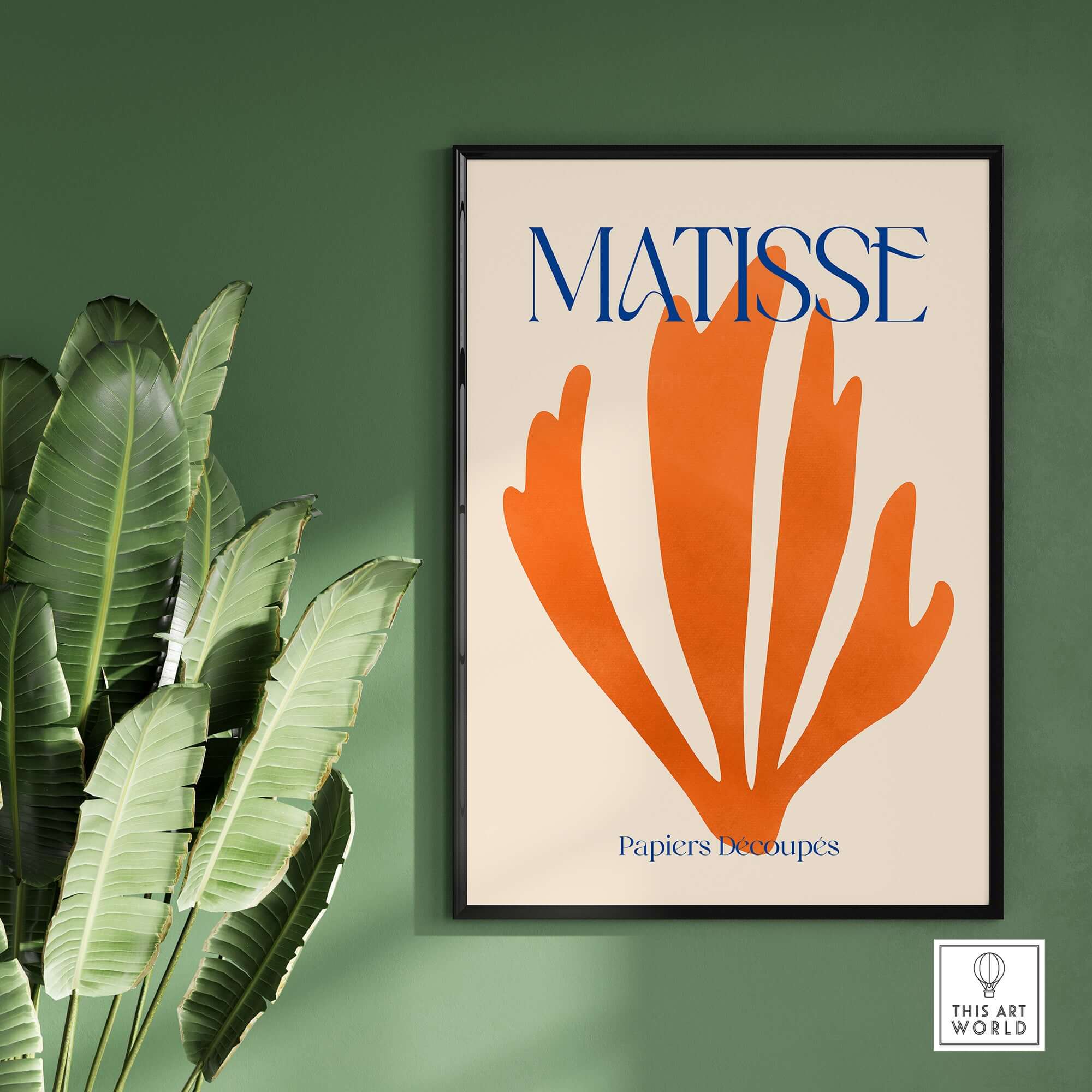 Matisse Papiers Découpés Orange Abstract Botanical Cut Out Art Print displayed on a green wall with palm leaves.