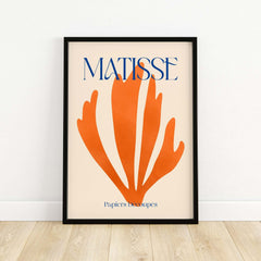 Matisse Papiers Découpés Orange Abstract Botanical Cut Out Art Print framed on a wall featuring a vibrant orange botanical design.