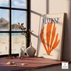 Matisse Papiers Découpés Orange Abstract Botanical Cut Out Art Print displayed in a modern interior with beach view.