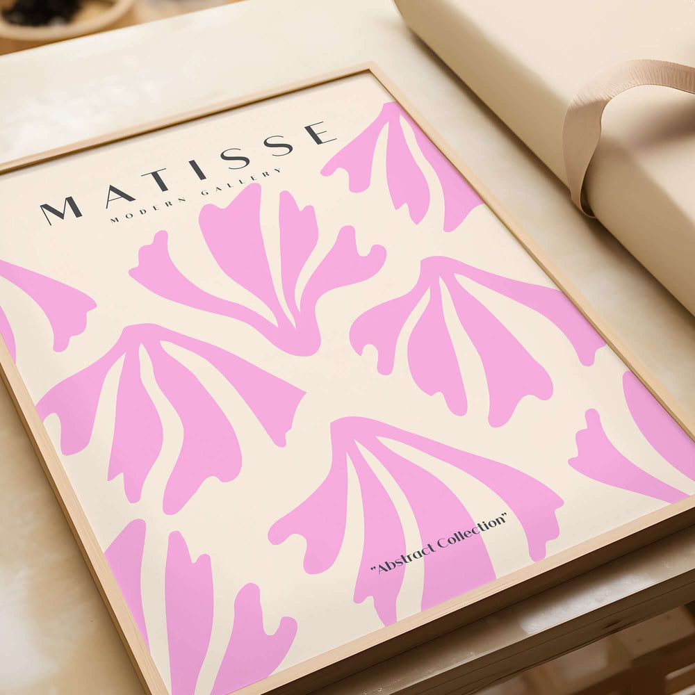 Matisse Art Prints - Pink Abstract Shapes Pattern Poster displayed in a stylish frame, featuring elegant pink shapes on beige.