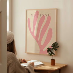 Matisse Art Prints - Pink Coral Leaf Abstract Botanical Poster displayed in a cozy setting with a person reading.