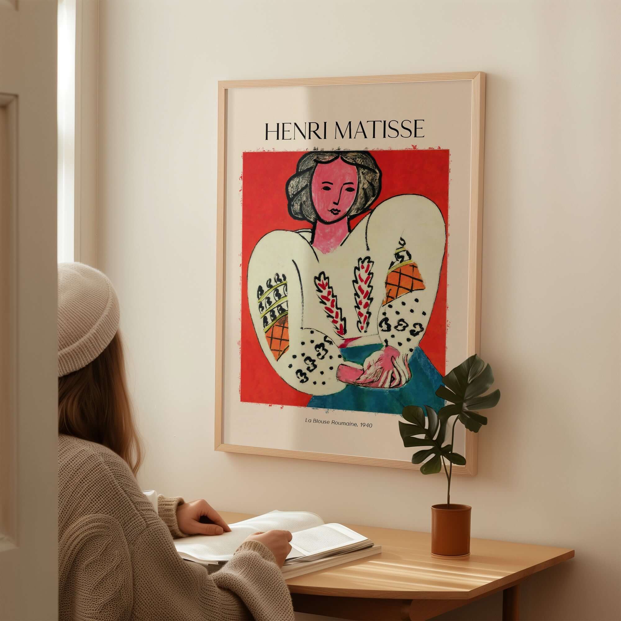 Matisse Poster - La Blouse Roumaine 1940 Famous Art Print displayed in a cozy room with a woman studying.