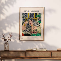 Matisse Poster - Odalisque with Black Armchair 1942 Art Print displayed on wall above a stylish wooden console.
