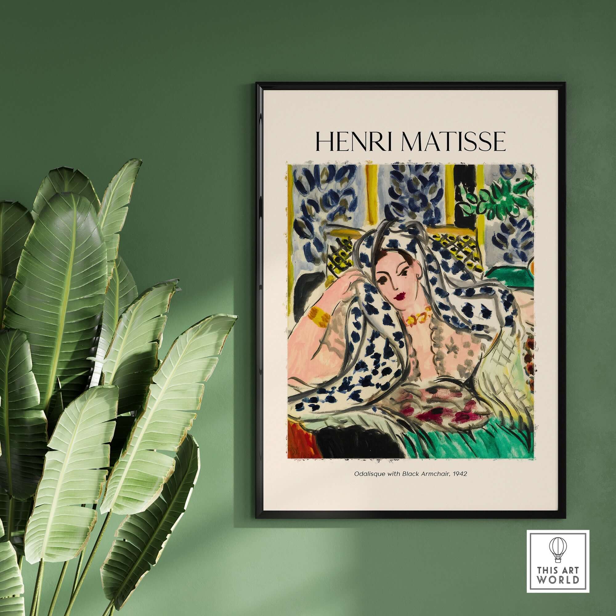 Matisse Poster - Odalisque with Black Armchair 1942 Art Print displayed on a green wall with tropical leaves.