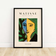 Matisse Art Prints - Split Face Blue Yellow Portrait Poster framed on a wall with abstract green and blue design.