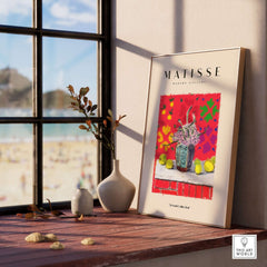 Matisse Art Prints - Still Life Flowers Lemons Red Pattern Poster displayed on a table near a window with beach view.