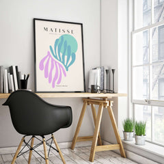Matisse Art Prints -Teal Pink Abstract Leaves Sun Poster displayed in modern workspace with stylish chair and plants.